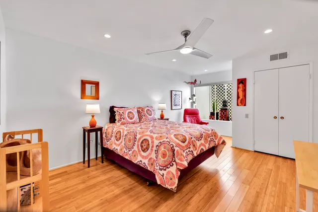 a bedroom with a bed and a dresser in it