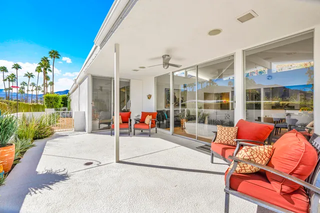 a building outdoor space with patio furniture and potted plants