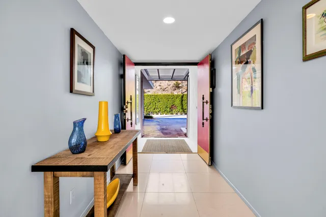 a hallway with a large window and couch