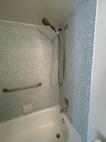 a bathroom with a shower and a shower