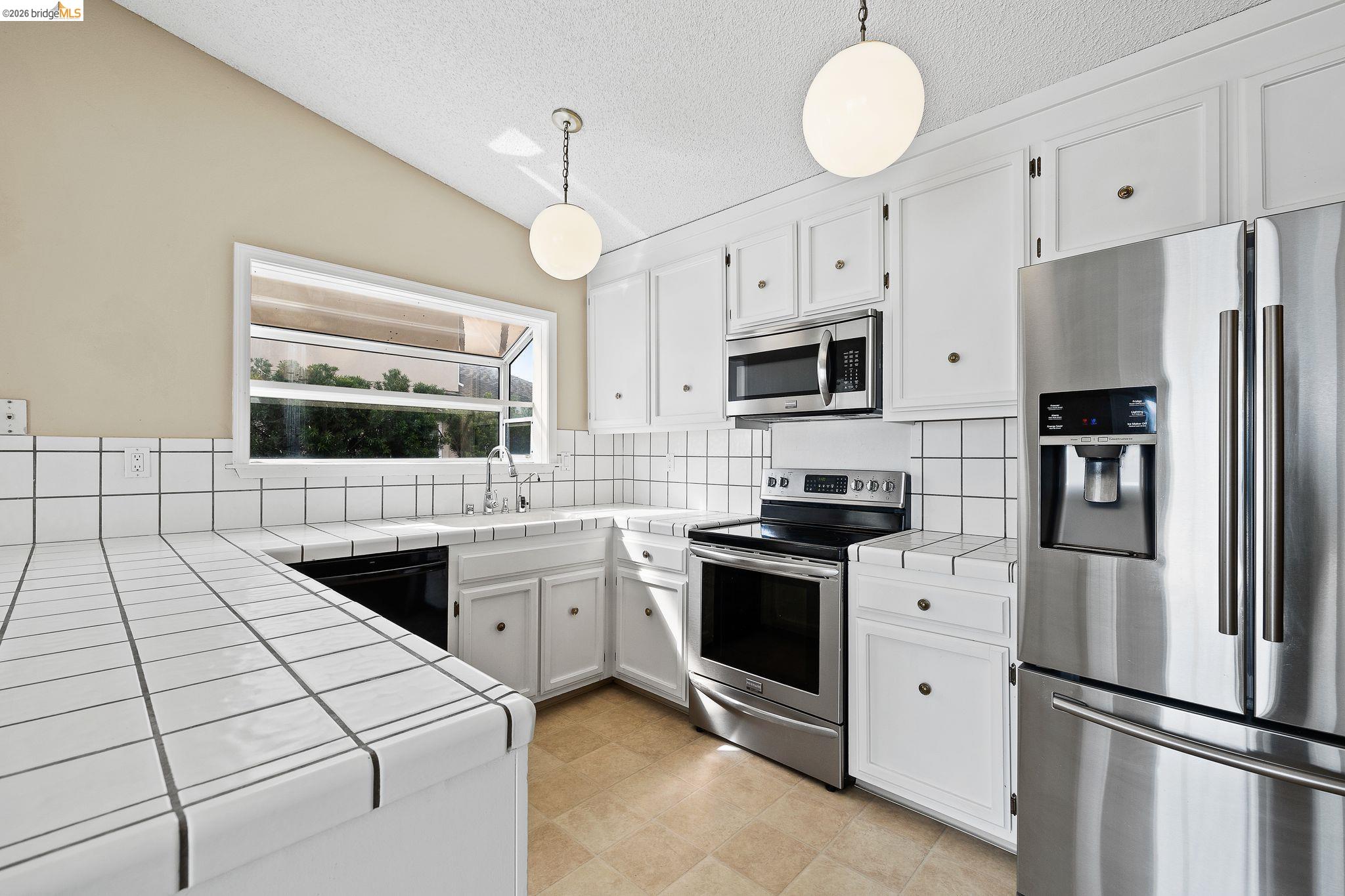 1147 Willow Lake Road Discovery Bay, CA 94505 - Photo 20 of 59 a kitchen with cabinets and stainless steel appliances