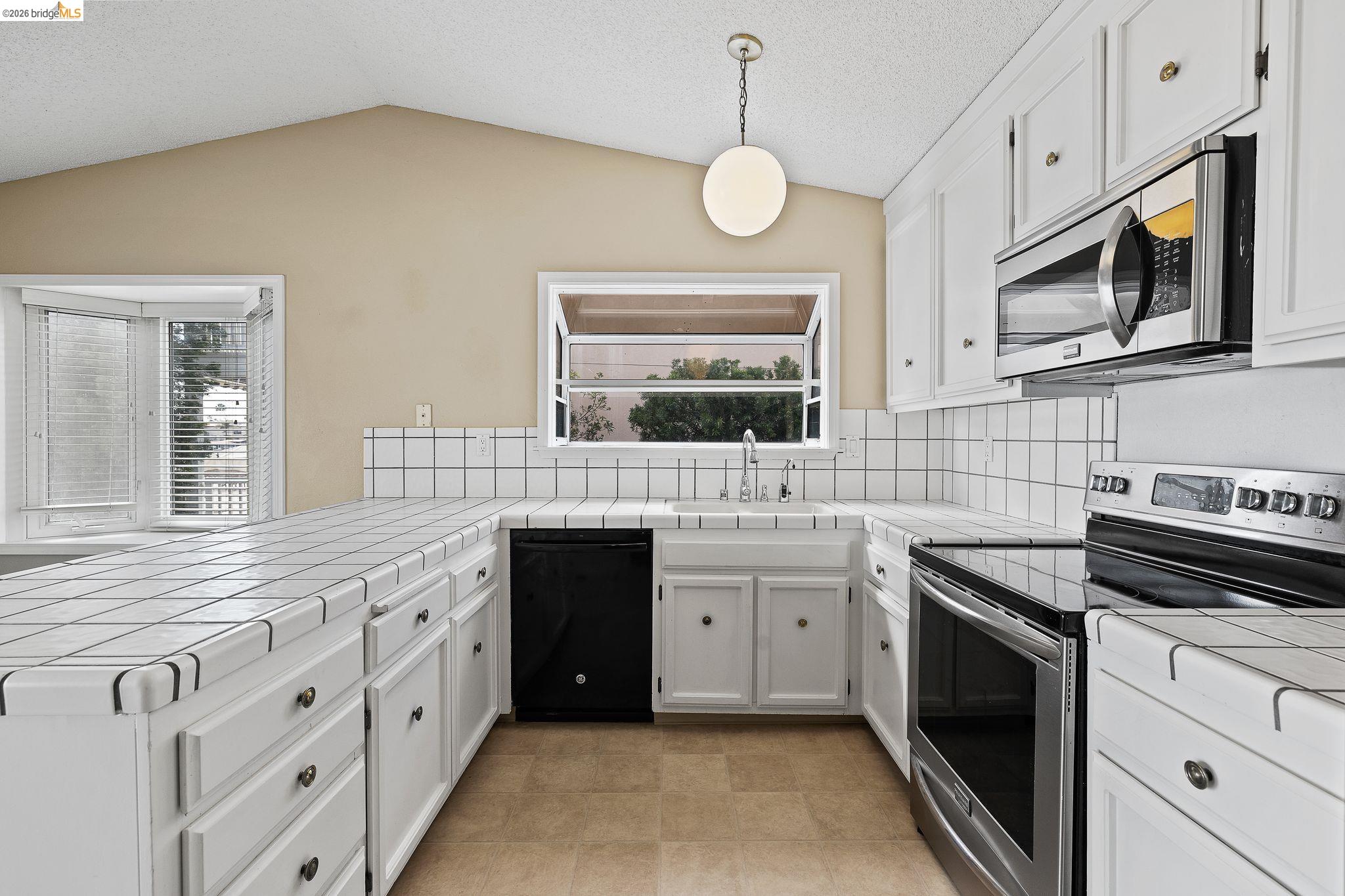 1147 Willow Lake Road Discovery Bay, CA 94505 - Photo 22 of 59 a kitchen with cabinets stainless steel appliances a sink and a window