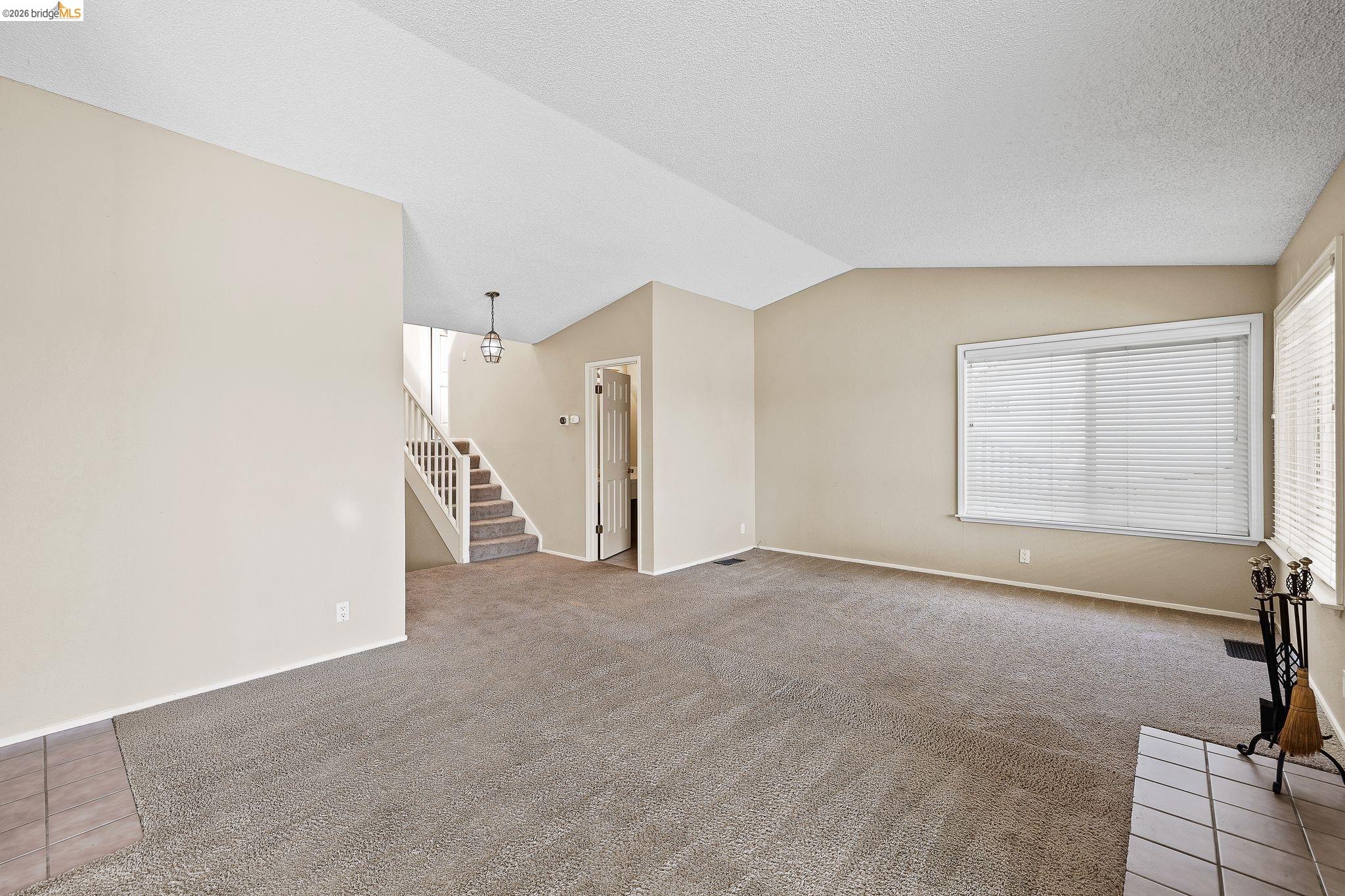 1147 Willow Lake Road Discovery Bay, CA 94505 - Photo 26 of 59 Unfurnished living room featuring light carpet and light tile patterned flooring