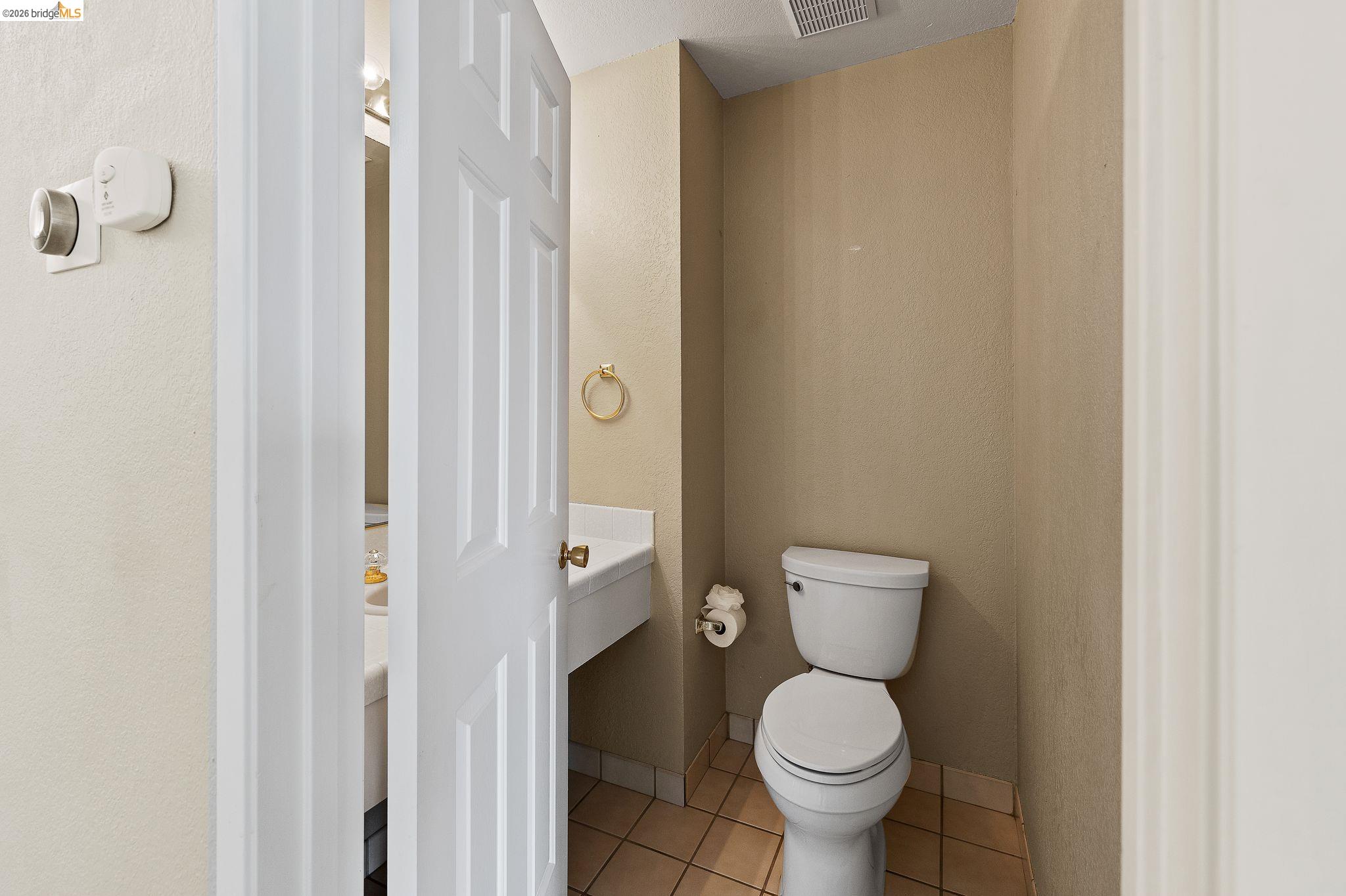 1147 Willow Lake Road Discovery Bay, CA 94505 - Photo 29 of 59 a white toilet sitting next to a bathroom sink
