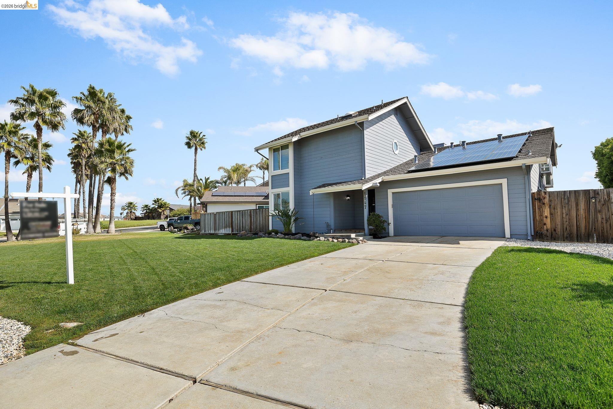 1147 Willow Lake Road Discovery Bay, CA 94505 - Photo 3 of 59 a front view of a house with a yard and garage