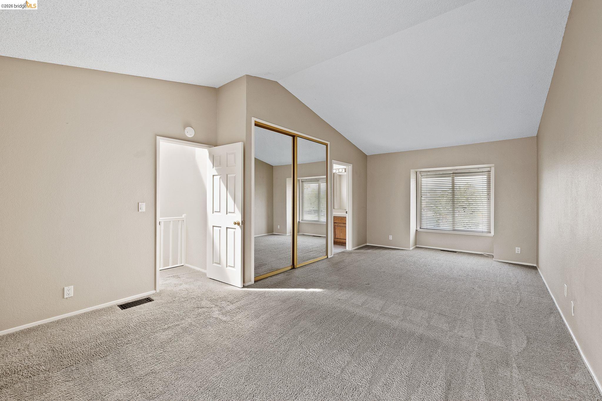 1147 Willow Lake Road Discovery Bay, CA 94505 - Photo 32 of 59 Unfurnished bedroom with a closet, light colored carpet, vaulted ceiling, and connected bathroom