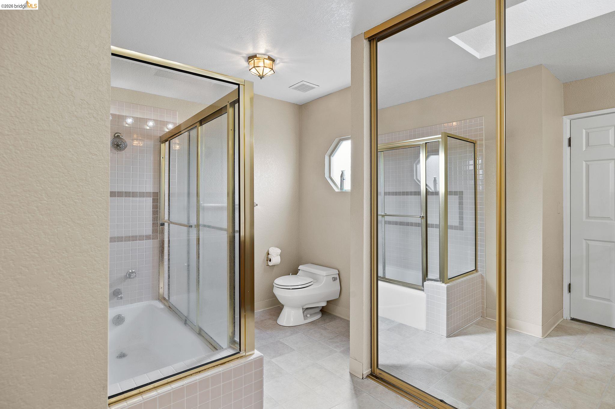 1147 Willow Lake Road Discovery Bay, CA 94505 - Photo 39 of 59 a bathroom with a glass shower door and a toilet