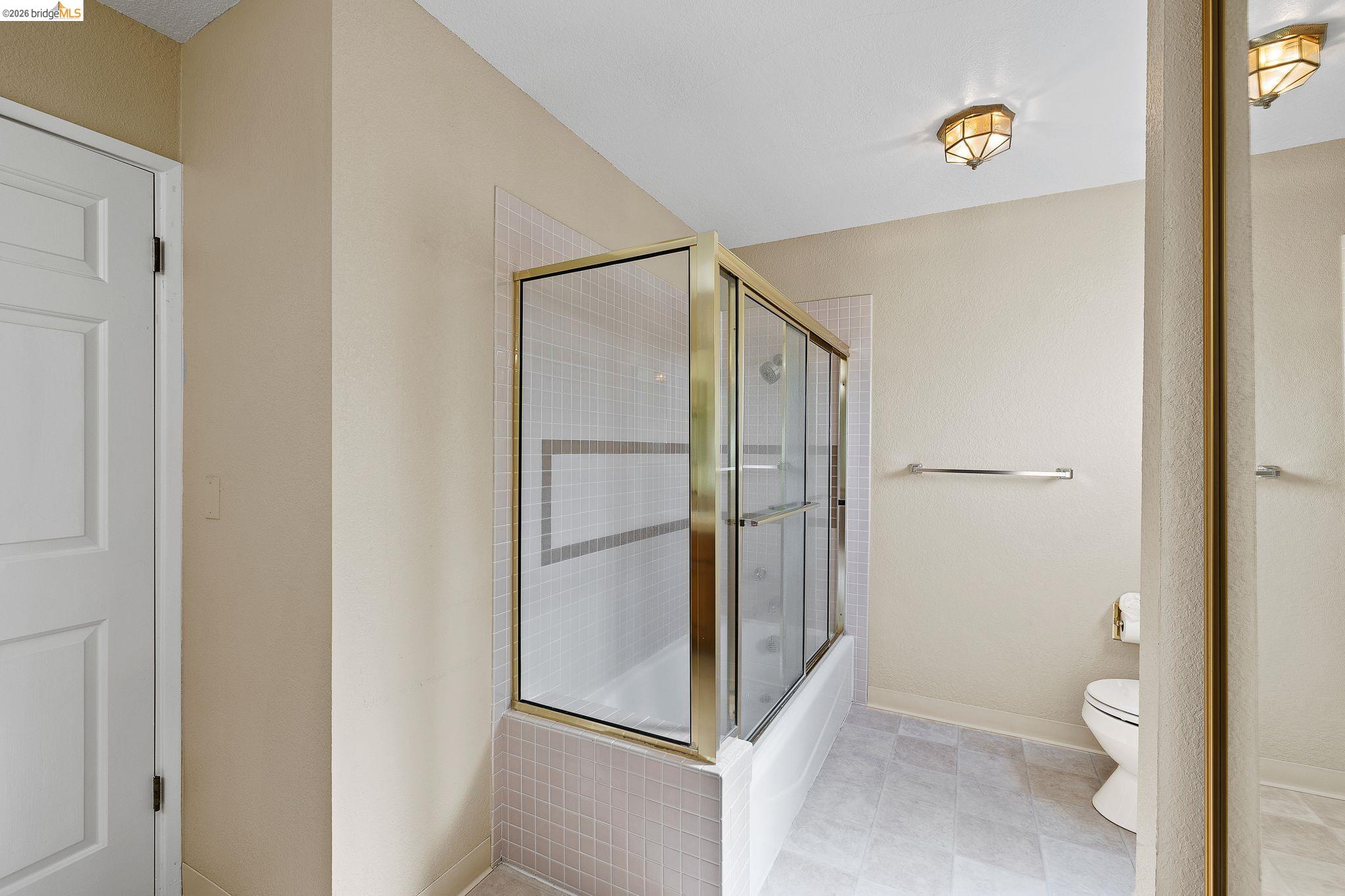 1147 Willow Lake Road Discovery Bay, CA 94505 - Photo 40 of 59 a bathroom with a granite countertop shower and a toilet