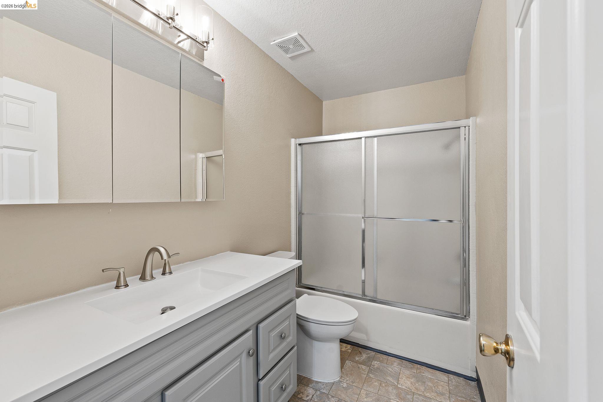 1147 Willow Lake Road Discovery Bay, CA 94505 - Photo 6 of 59 a bathroom with a white sink a toilet and a shower