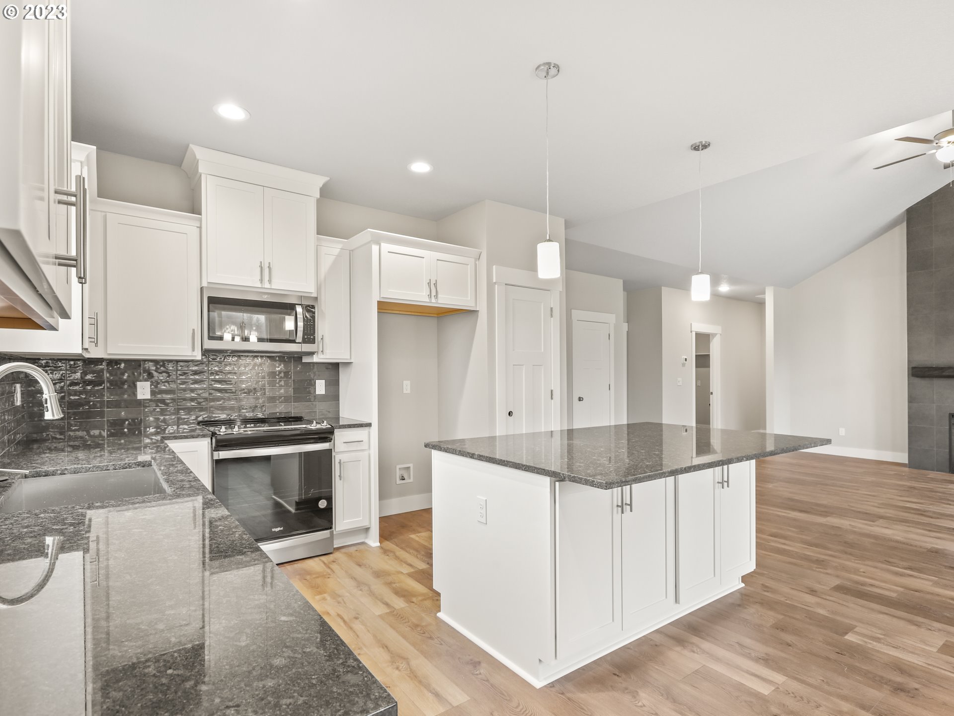 652 Northeast Pinebreak Drive Estacada, OR 97023 - Photo 11 of 40 a large kitchen with stainless steel appliances granite countertop a stove and a sink