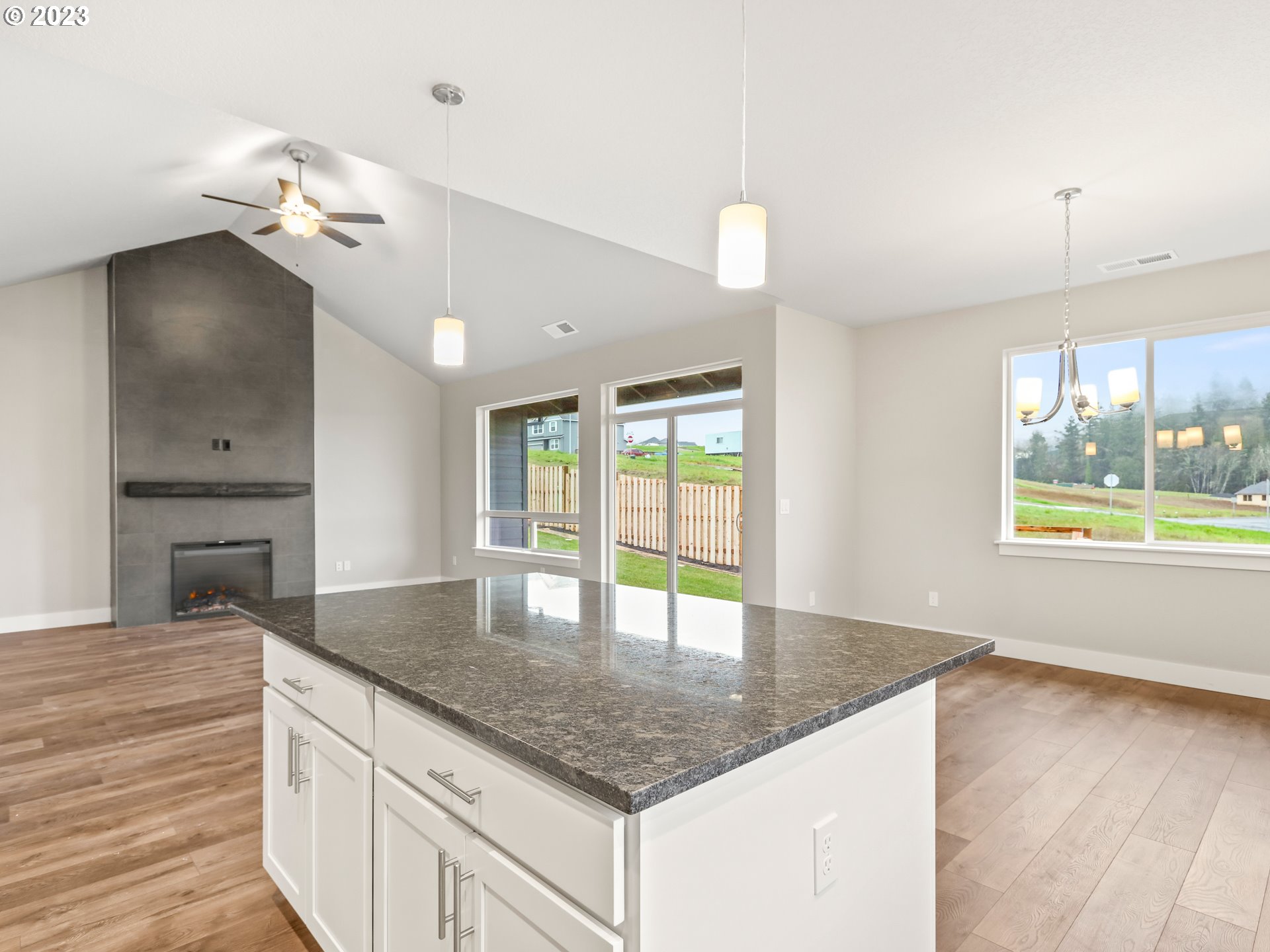 652 Northeast Pinebreak Drive Estacada, OR 97023 - Photo 13 of 40 a kitchen with kitchen island a counter appliances and a large window