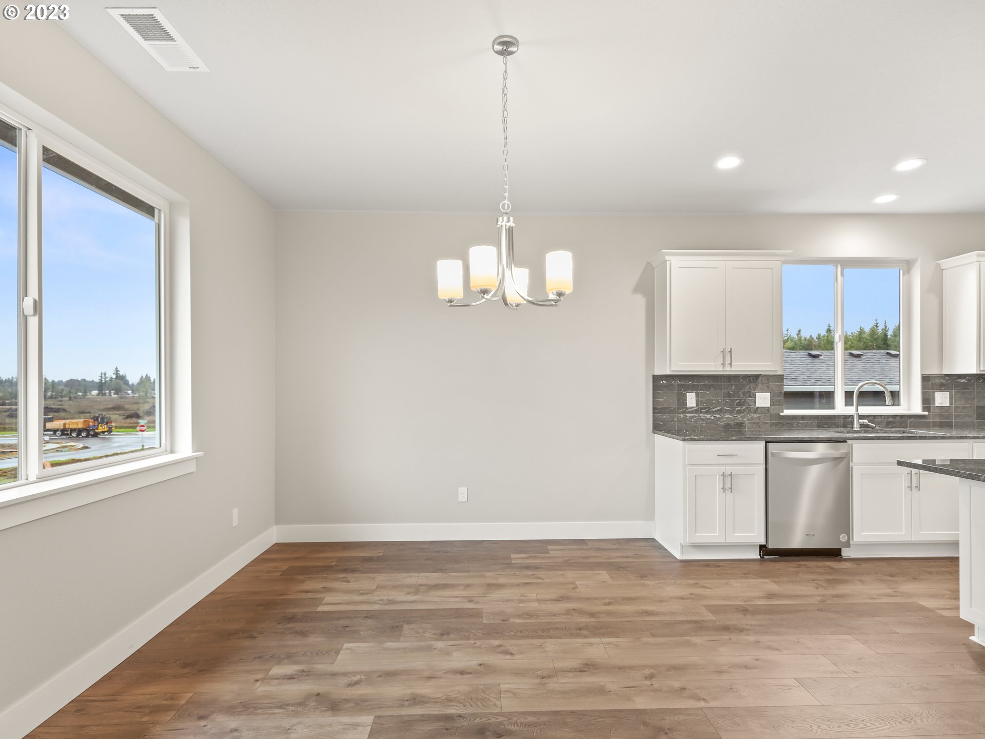 652 Northeast Pinebreak Drive Estacada, OR 97023 - Photo 14 of 40 a view of a kitchen with stainless steel appliances granite countertop cabinets and a wooden floor