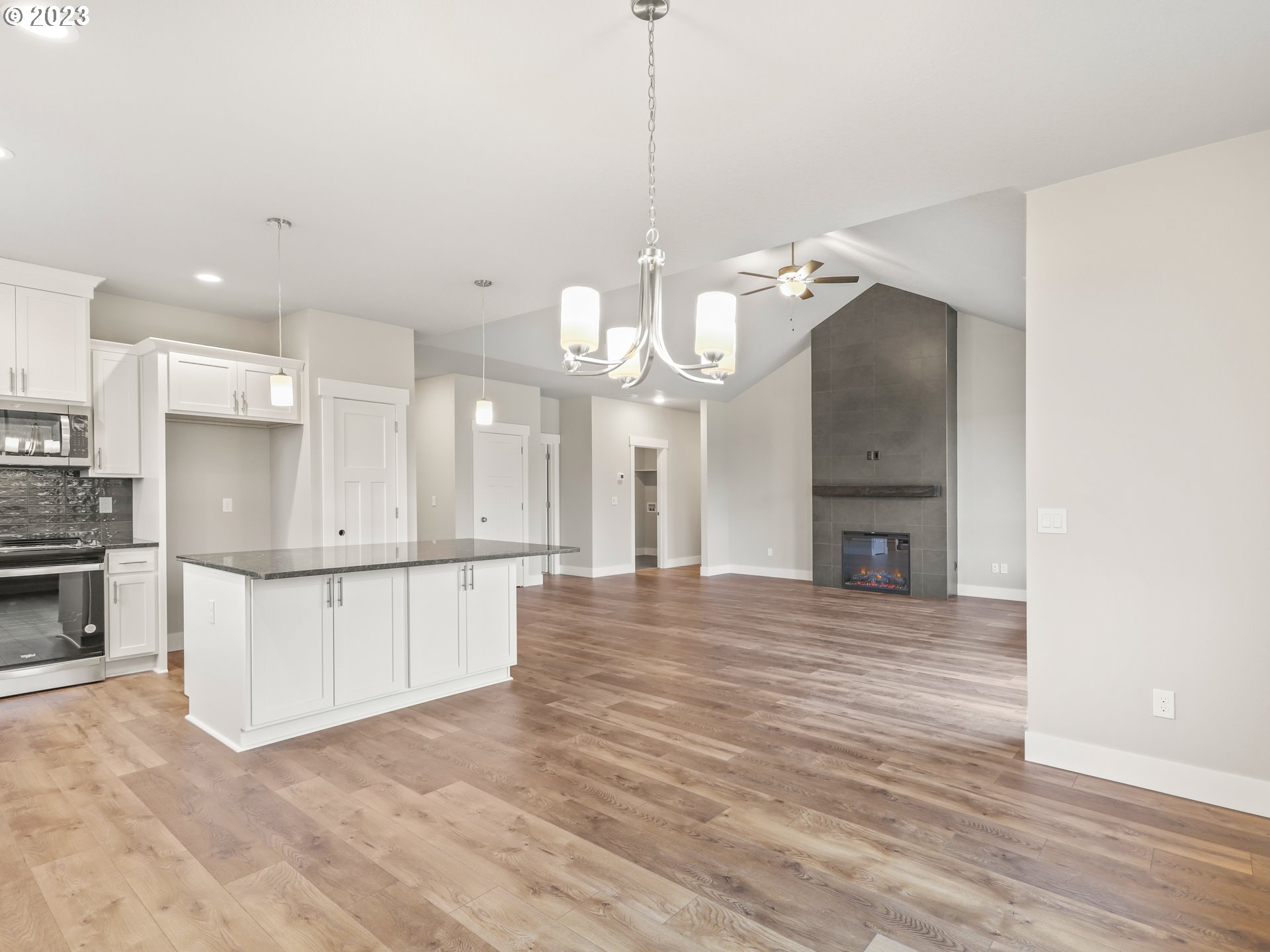 652 Northeast Pinebreak Drive Estacada, OR 97023 - Photo 15 of 40 a view of a kitchen with a sink and dishwasher a kitchen island with wooden floor