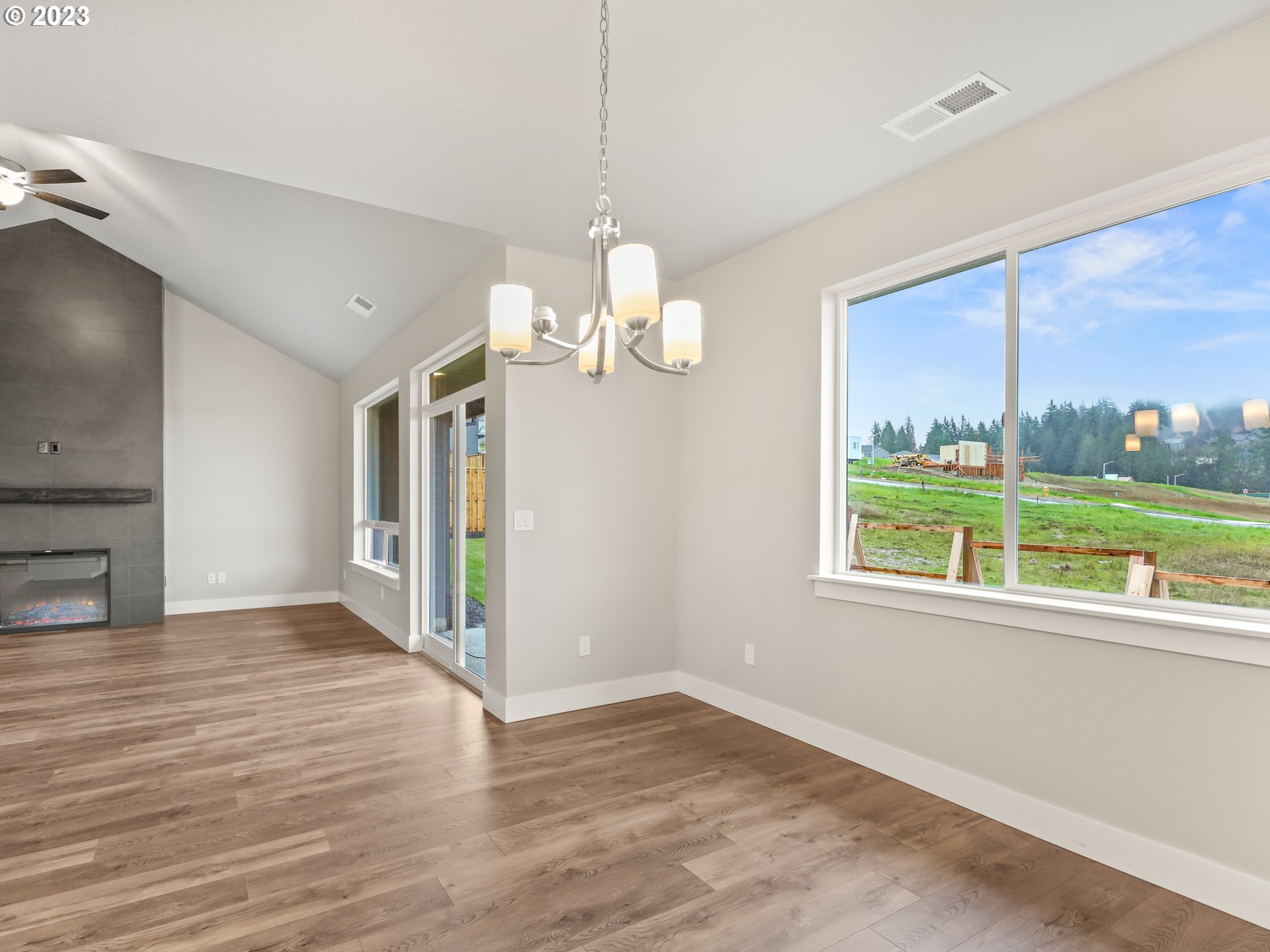 652 Northeast Pinebreak Drive Estacada, OR 97023 - Photo 16 of 40 a view of an empty room with wooden floor and a window