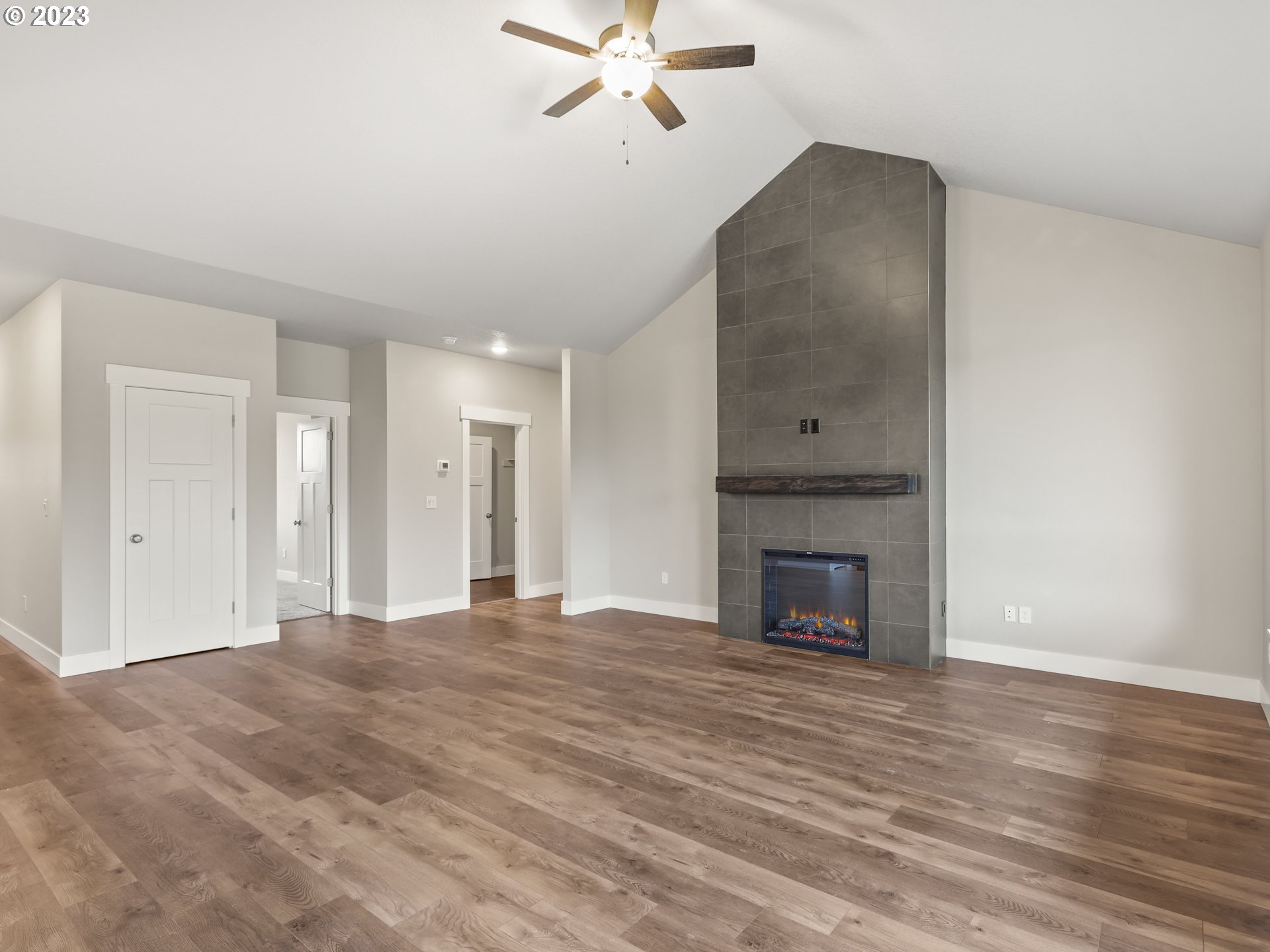 652 Northeast Pinebreak Drive Estacada, OR 97023 - Photo 17 of 40 a view of an empty room with wooden floor fireplace and a window