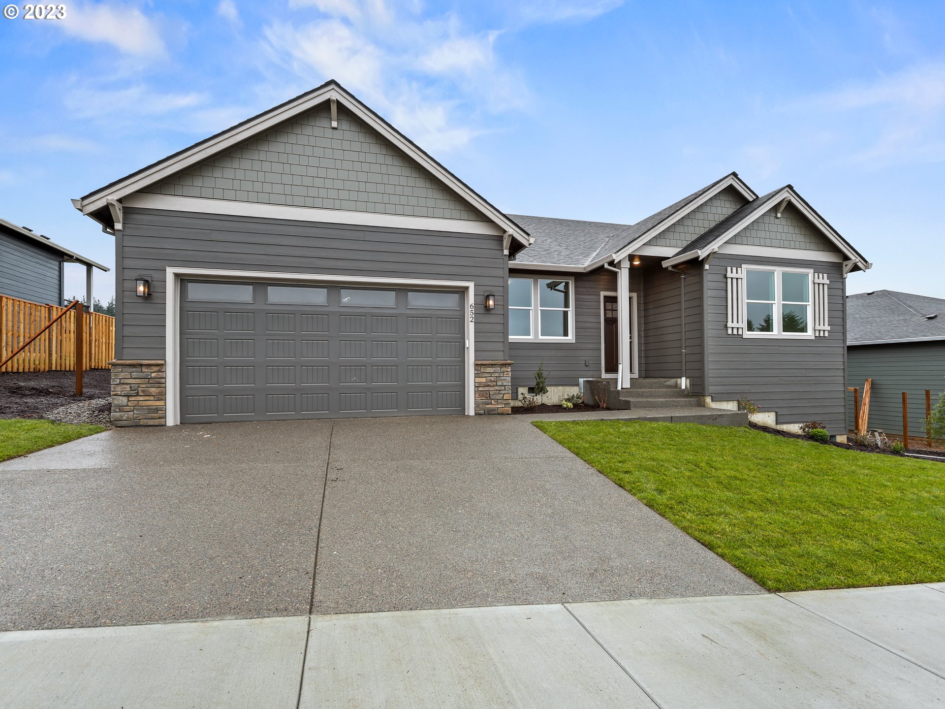 652 Northeast Pinebreak Drive Estacada, OR 97023 - Photo 2 of 40 a front view of a house with a yard and garage