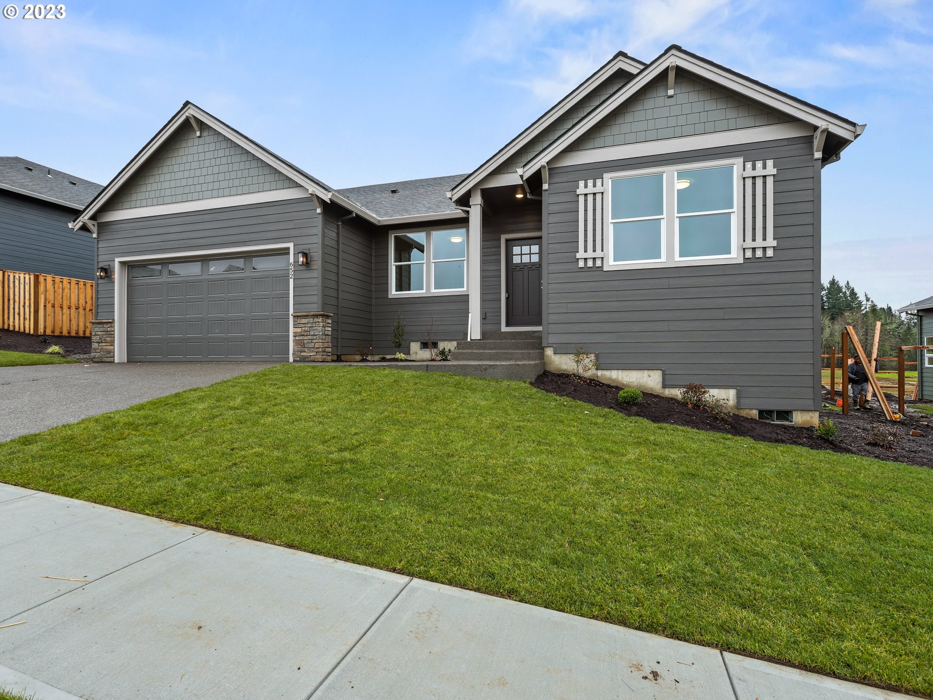 652 Northeast Pinebreak Drive Estacada, OR 97023 - Photo 3 of 40 a front view of a house with a yard and garage