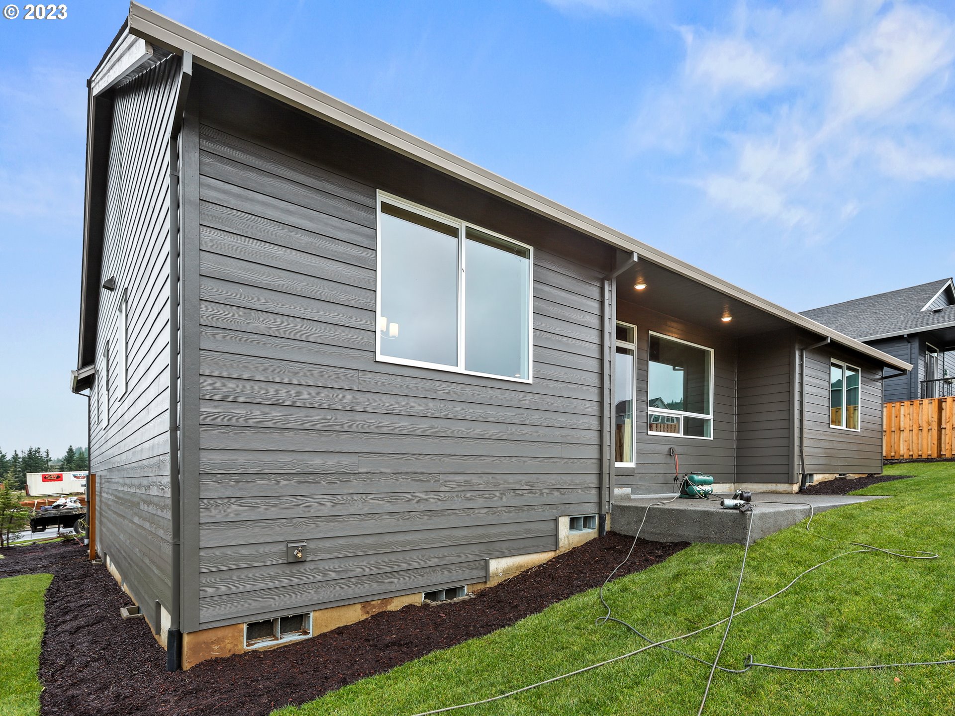 652 Northeast Pinebreak Drive Estacada, OR 97023 - Photo 37 of 40 a backyard of a house with table and chairs