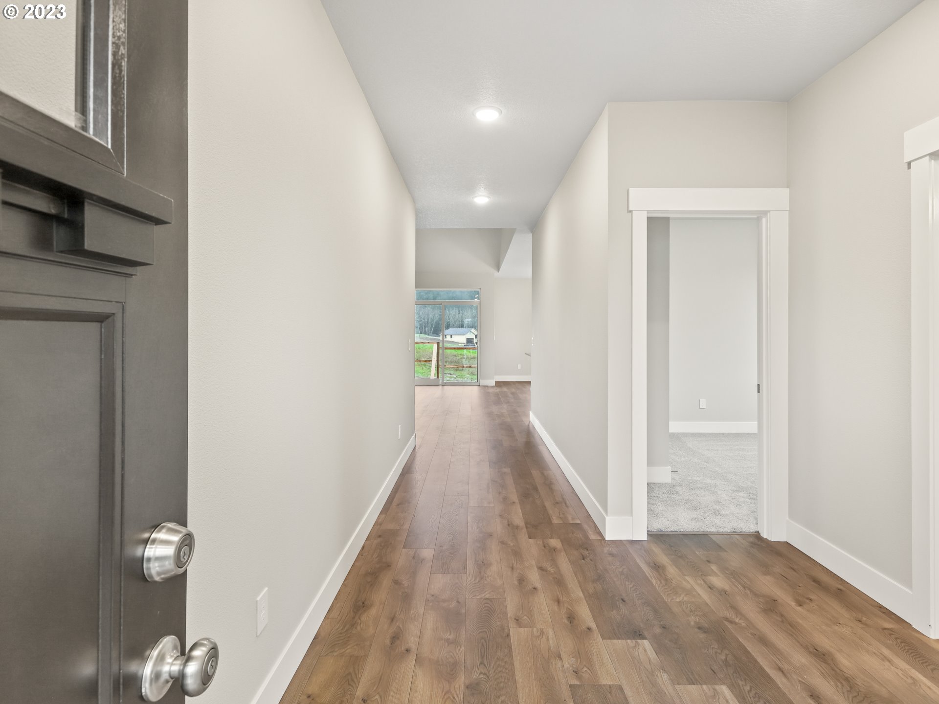 652 Northeast Pinebreak Drive Estacada, OR 97023 - Photo 4 of 40 a view of a hallway with wooden floor and staircase
