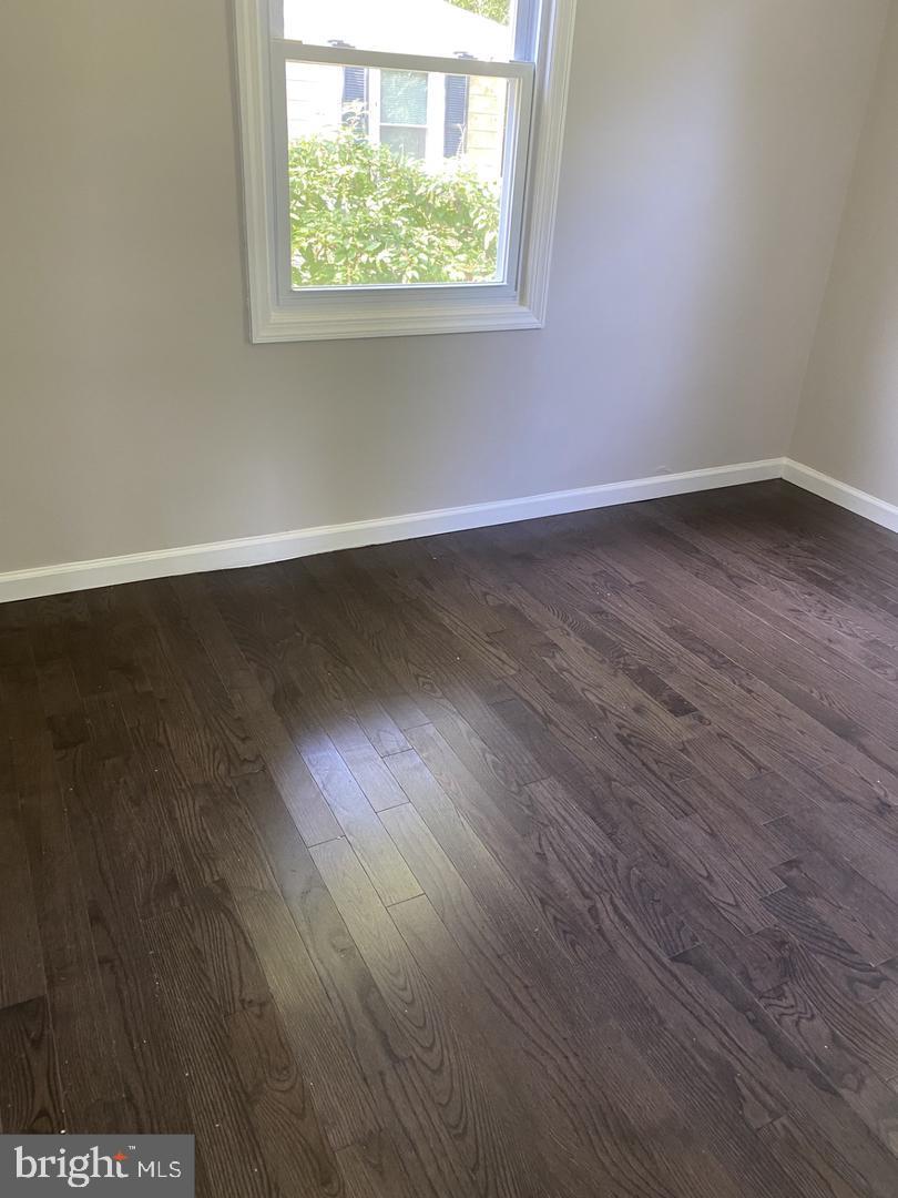 111 Edison Road Cherry Hill, NJ 08034 - Photo 7 of 8 an empty room with wooden floor and windows
