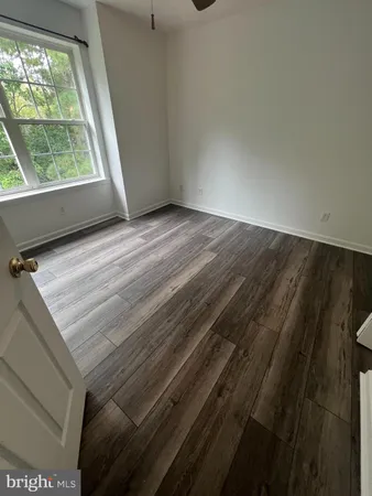 a view of wooden floor and windows in a room