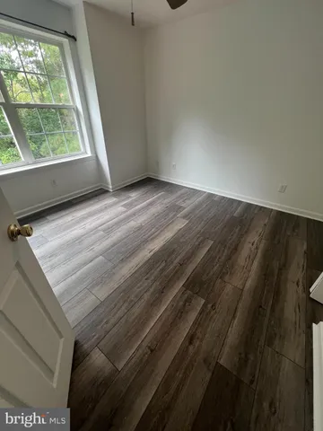a view of wooden floor and windows in a room