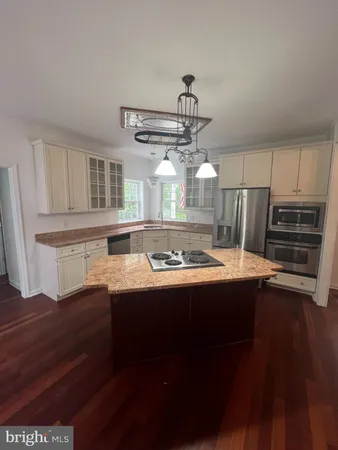 a view of a kitchen with a sink and stainless steel appliances