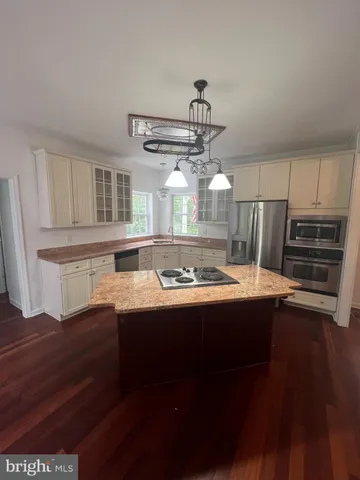a view of a kitchen with a sink and stainless steel appliances