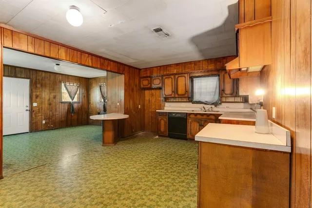 a kitchen with a sink a stove and cabinets