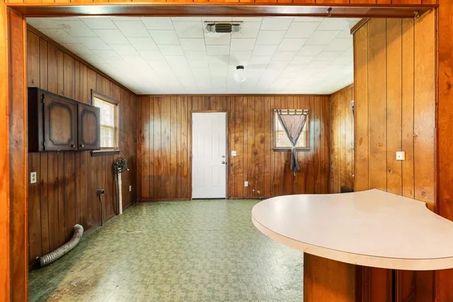 a view of a kitchen with furniture and wooden cabinets