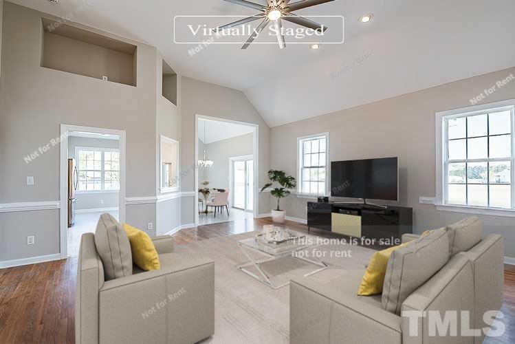 8909 Sauls Road Raleigh, NC 27603 - Photo 2 of 23 a living room with furniture and a flat screen tv