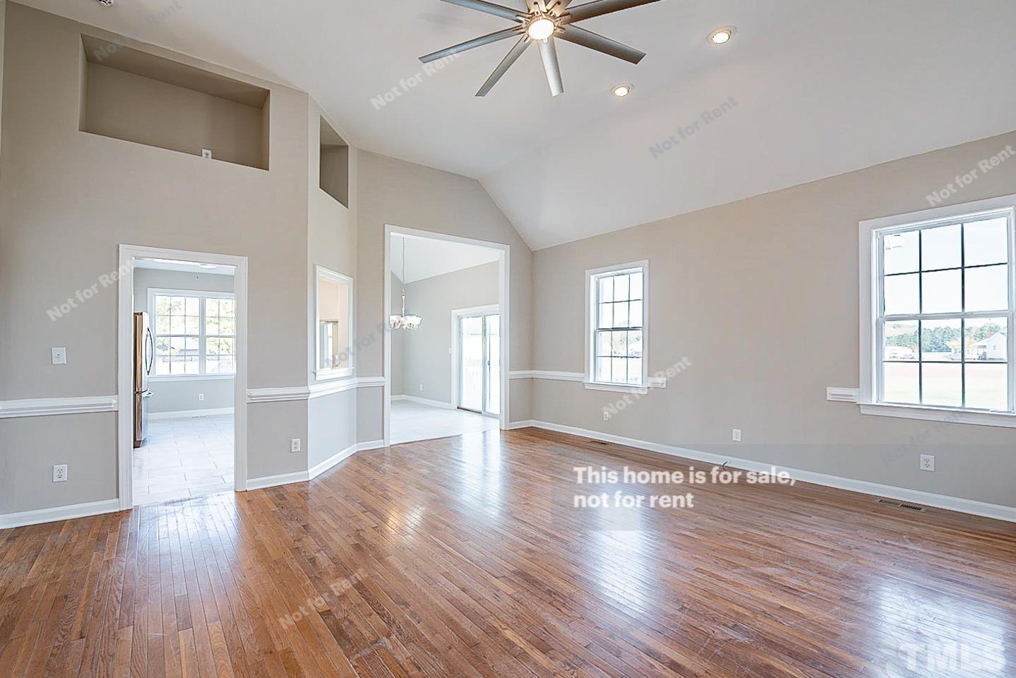 8909 Sauls Road Raleigh, NC 27603 - Photo 11 of 23 a view of an empty room with wooden floor and a window
