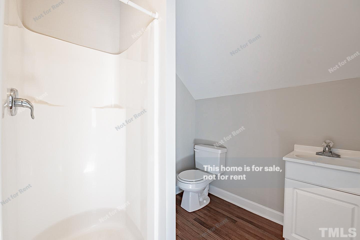 8909 Sauls Road Raleigh, NC 27603 - Photo 16 of 23 a bathroom with a toilet and a sink
