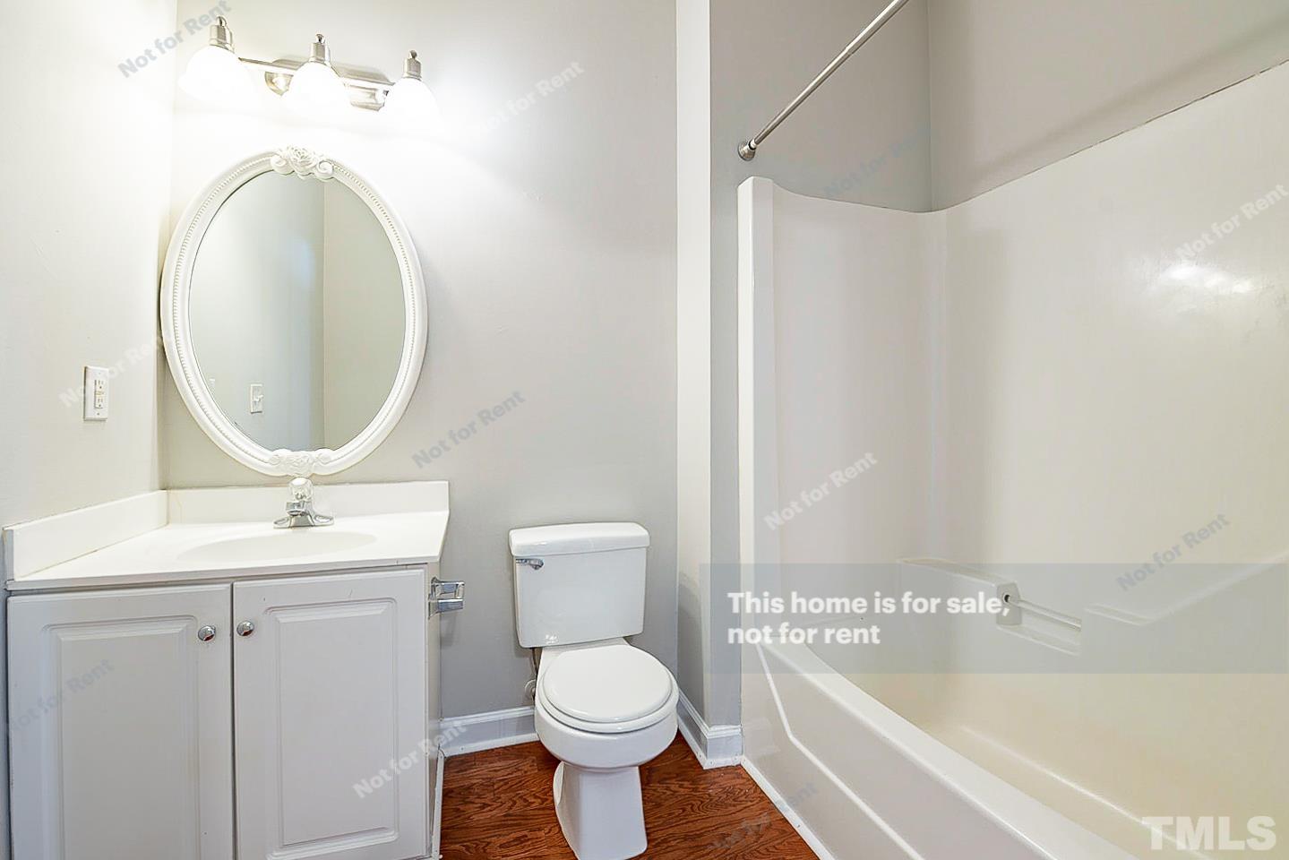 8909 Sauls Road Raleigh, NC 27603 - Photo 20 of 23 a bathroom with a toilet sink and mirror