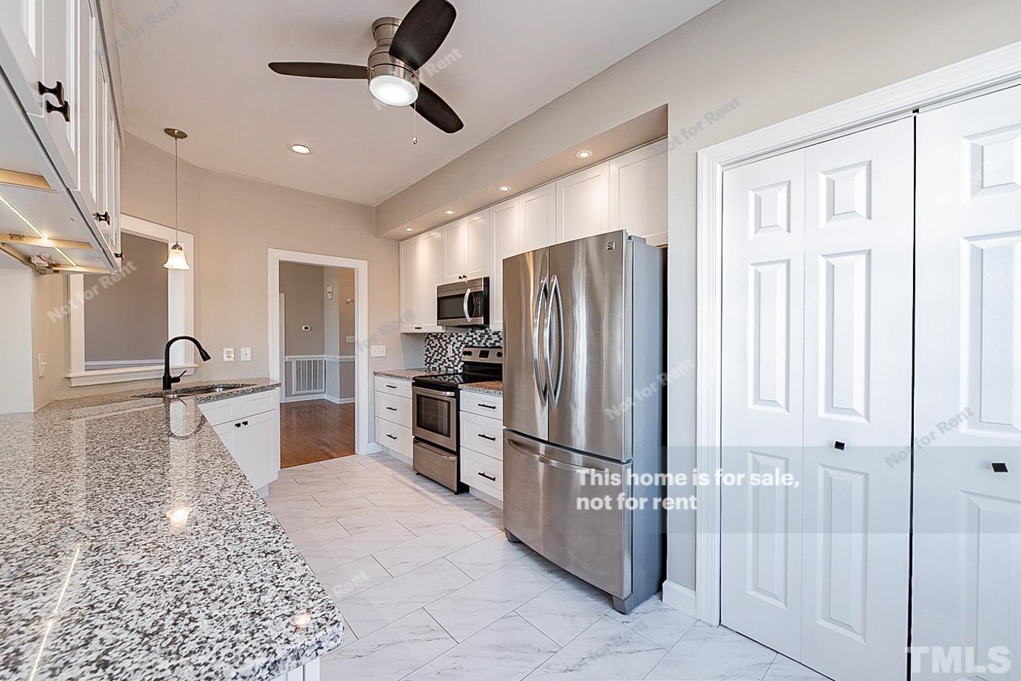 8909 Sauls Road Raleigh, NC 27603 - Photo 9 of 23 a kitchen with stainless steel appliances granite countertop a refrigerator and a sink