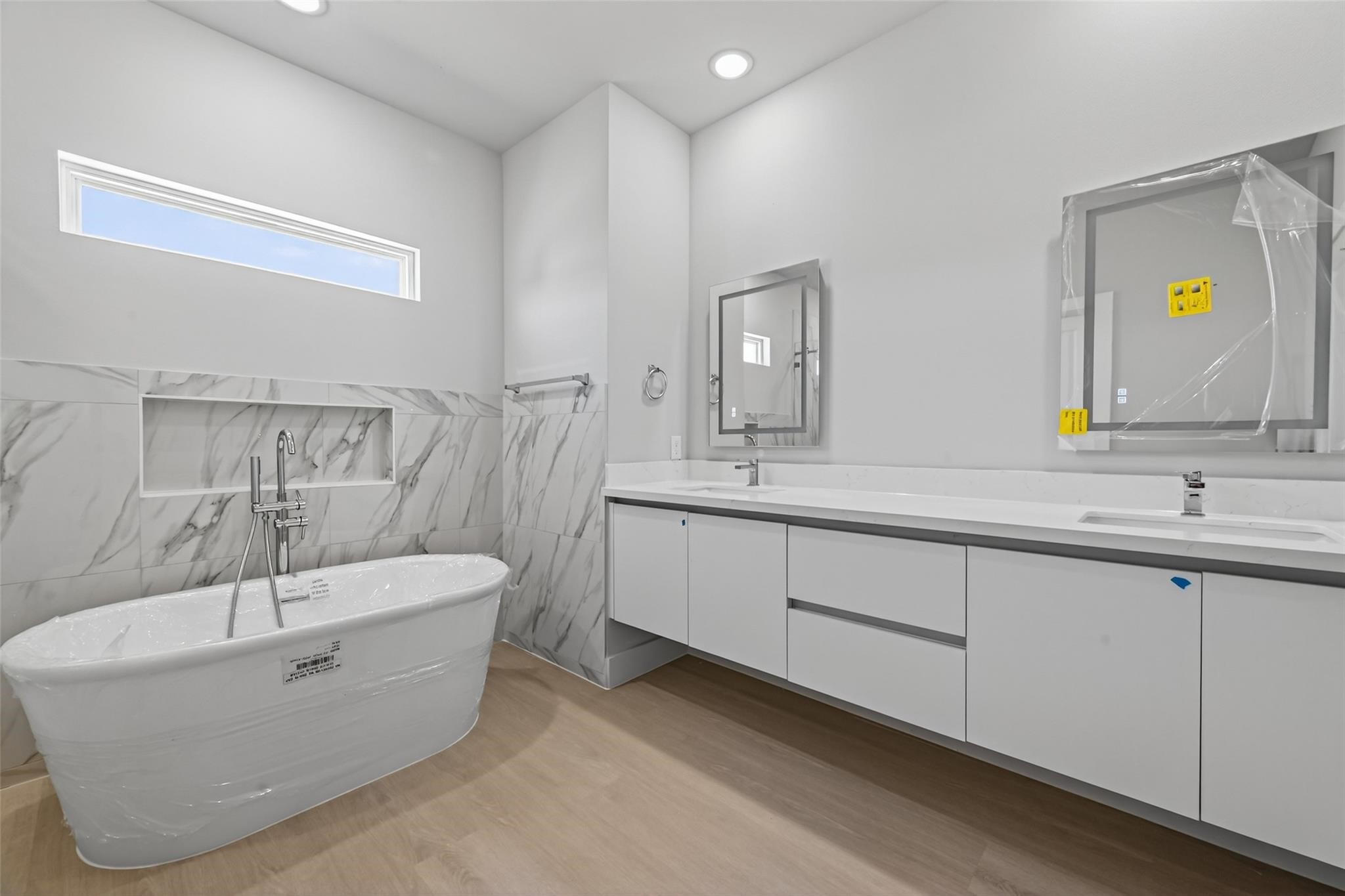 6702 Metro Boulevard, Unit 3 Houston, TX 77083 - Photo 12 of 29 The primary bathroom features double sinks, a soaking tub, and a luxurious walk-in shower