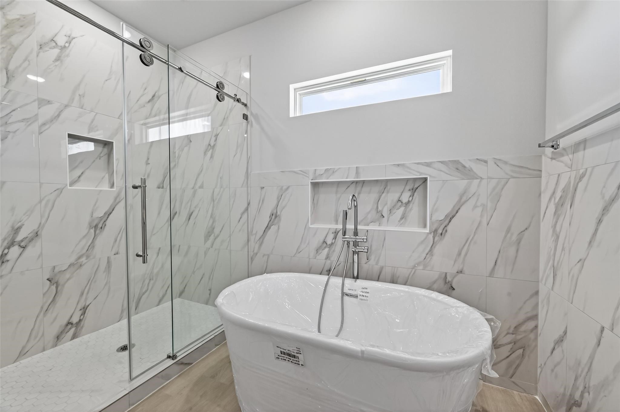 6702 Metro Boulevard, Unit 3 Houston, TX 77083 - Photo 13 of 29 The primary bathroom features double sinks, a soaking tub, and a luxurious walk-in shower