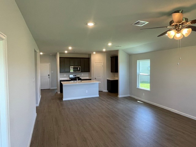 1024 Legrand Street Brenham, TX 77833 - Photo 3 of 7 a kitchen with stainless steel appliances granite countertop a refrigerator and a stove