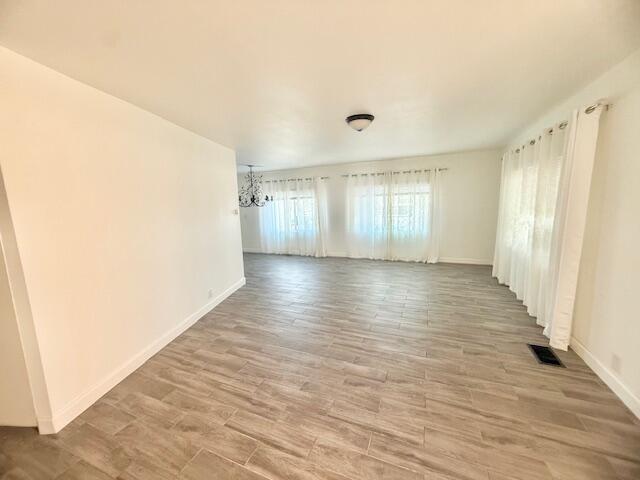 51555 Monroe Street Indio, CA 92201 - Photo 11 of 29 a view of an empty room with wooden floor and a window
