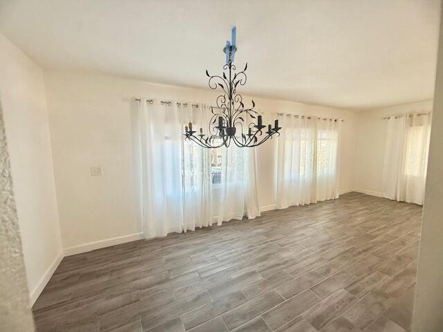 51555 Monroe Street Indio, CA 92201 - Photo 14 of 29 a view of a room with wooden floor and chandelier