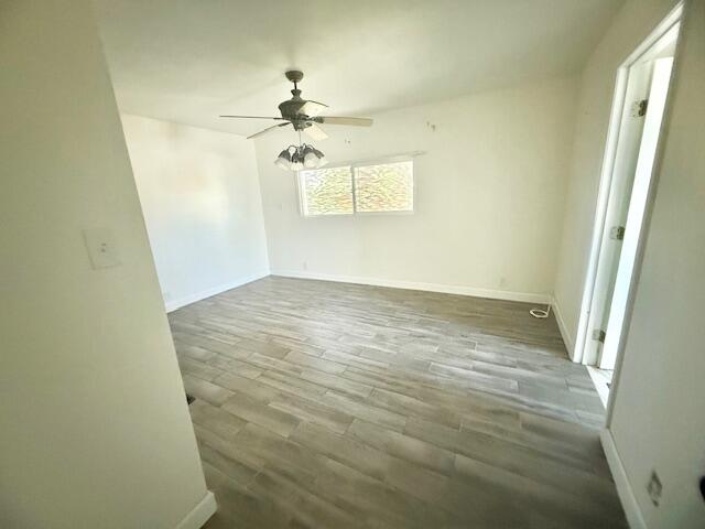51555 Monroe Street Indio, CA 92201 - Photo 16 of 29 an empty room with a chandelier fan and windows