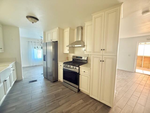 51555 Monroe Street Indio, CA 92201 - Photo 3 of 29 a kitchen with stainless steel appliances granite countertop a refrigerator and a stove top oven