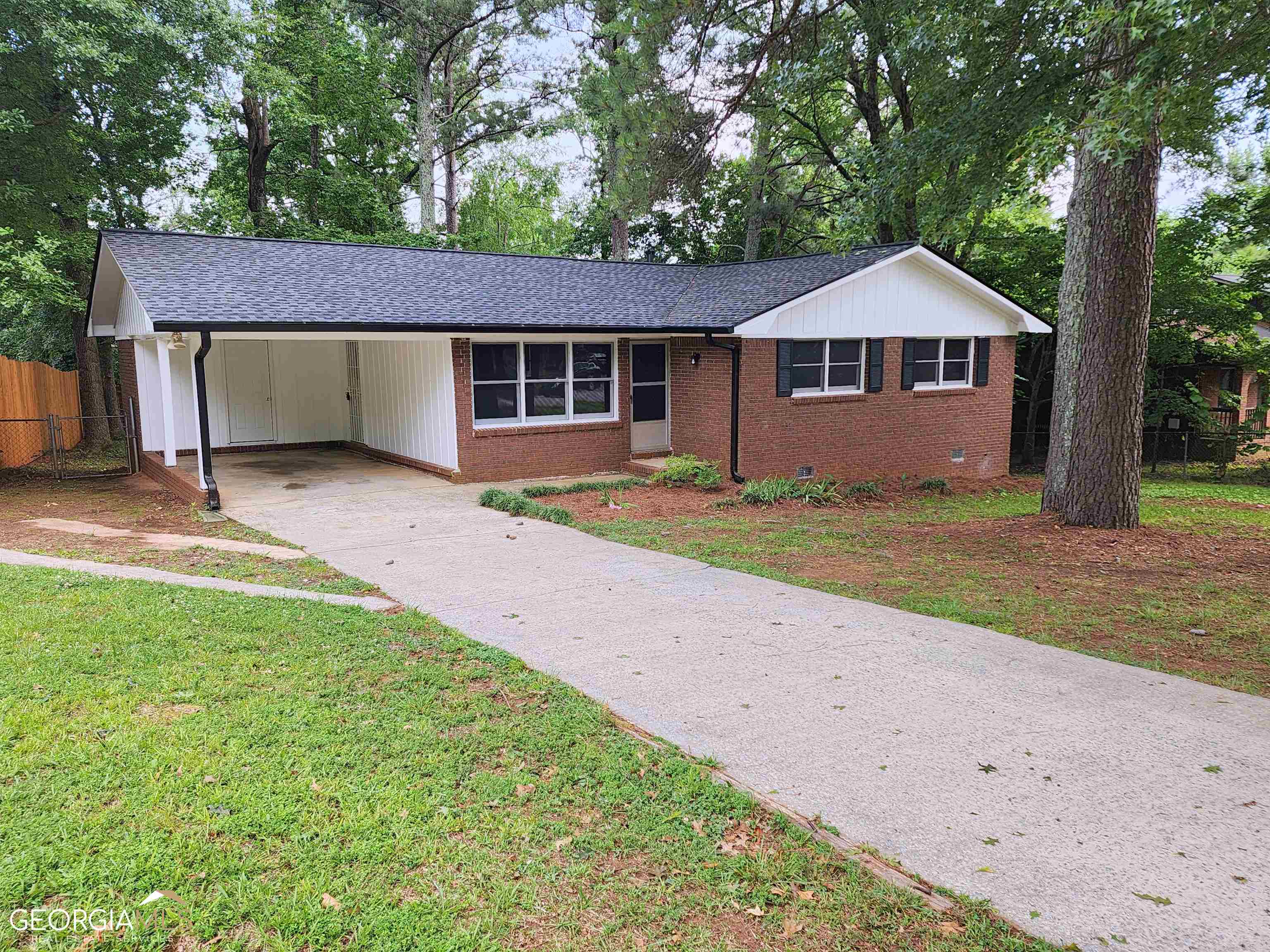 6762 Bedford Road Rex, GA 30273 - Photo 1 of 1 a front view of a house with a garden and yard