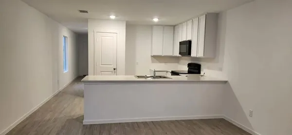 a view of kitchen with stainless steel appliances granite countertop refrigerator sink and stove