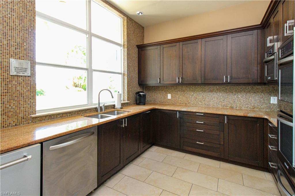 9123 Strada Place, Unit 7410 Naples, FL 34108 - Photo 20 of 50 Kitchen with appliances with stainless steel finishes, sink, light tile patterned flooring, and a healthy amount of sunlight