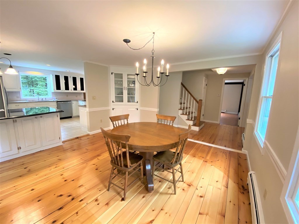 49 Mill Road Boxford, MA 01921 - Photo 6 of 40 a view of a dining room with furniture and wooden floor