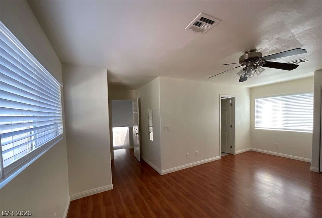 7203 Cestrum Road Las Vegas, NV 89113 - Photo 15 of 22 Rich hardwood floors sweep through an open interior featuring clean walls and ample natural light.