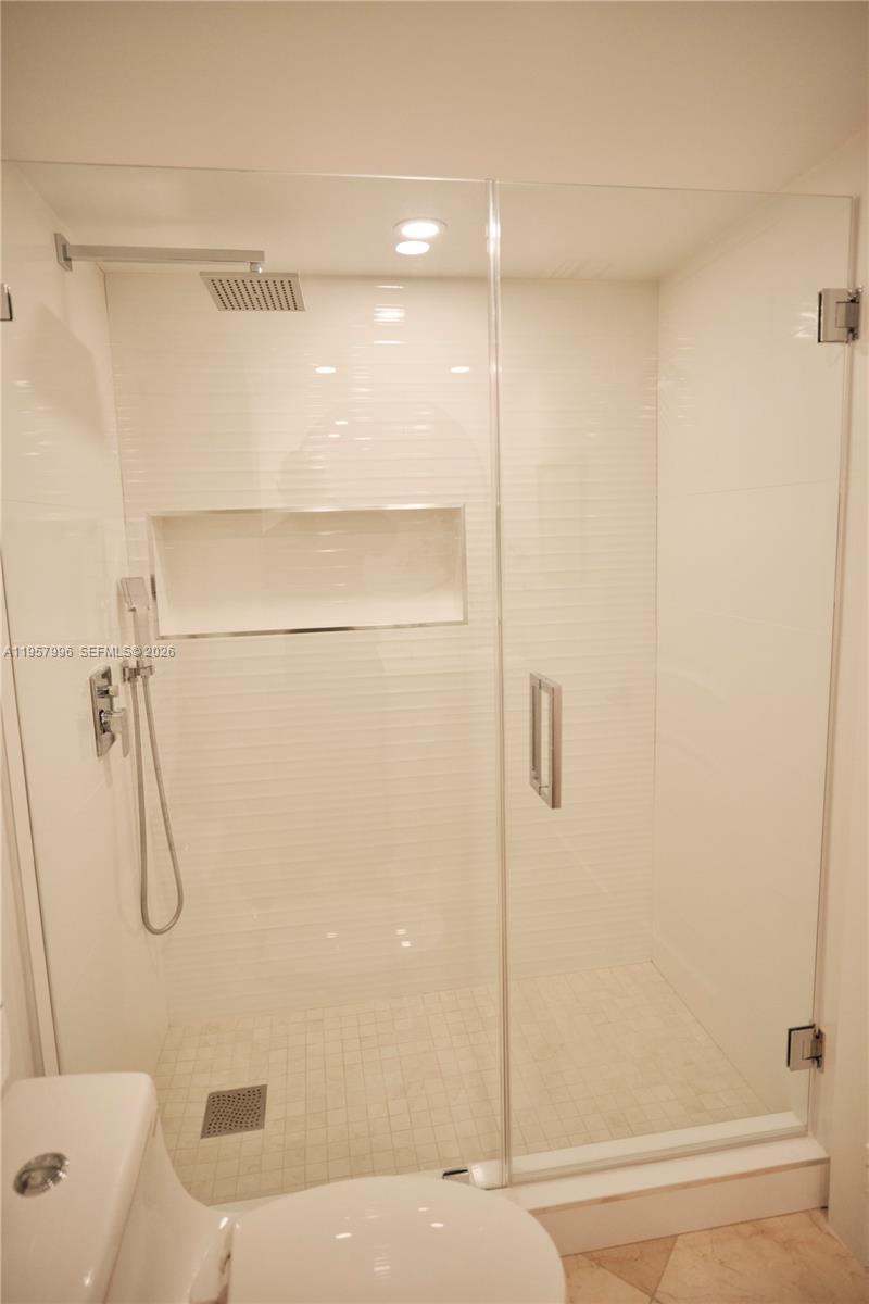 520 Brickell Key Drive, Unit A1904 Miami, FL 33131 - Photo 14 of 27 a bathroom with a shower and a bath tub