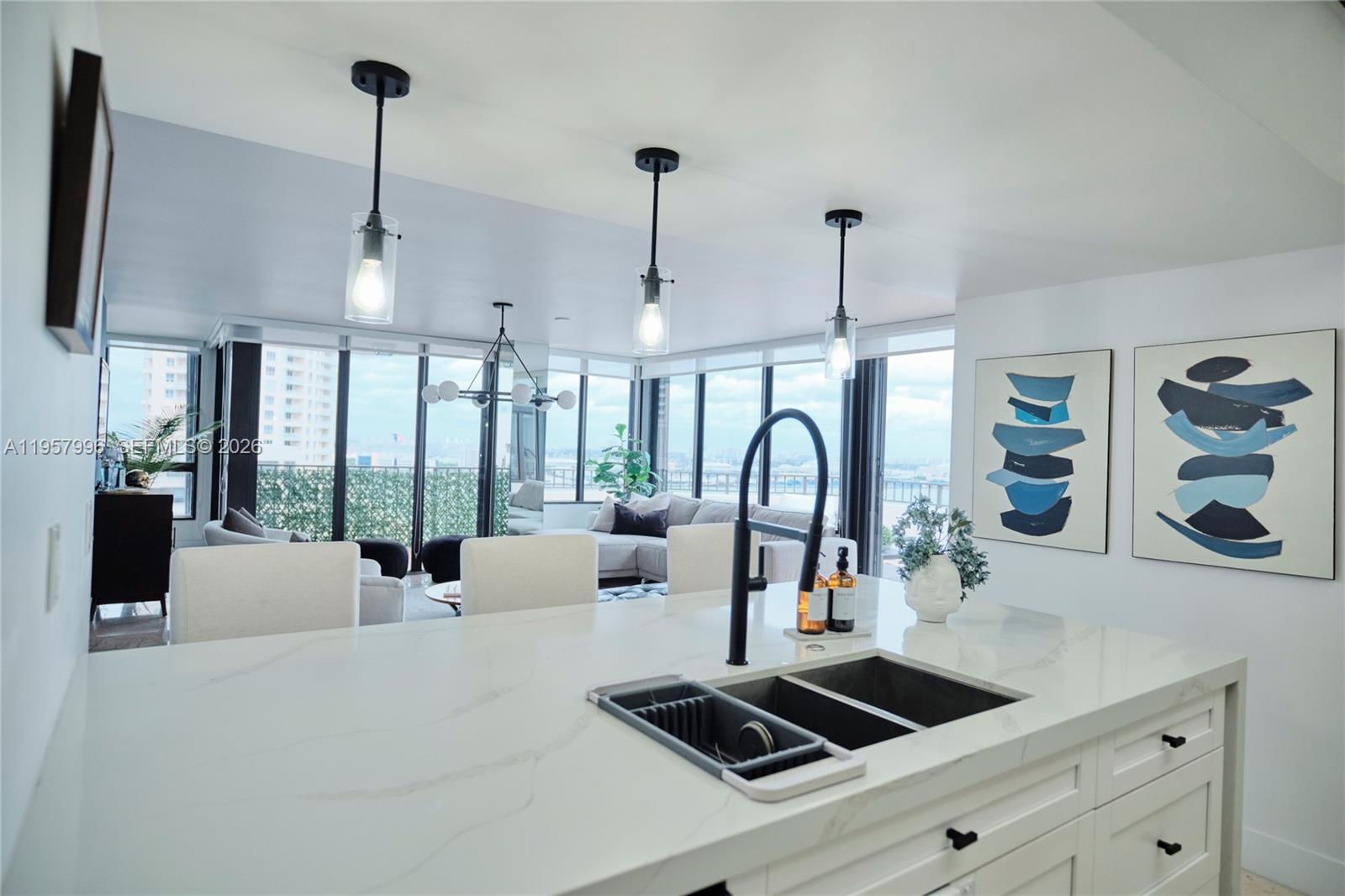 520 Brickell Key Drive, Unit A1904 Miami, FL 33131 - Photo 20 of 27 a kitchen with a stove and a view of living room