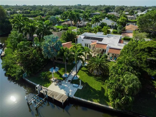 an aerial view of residential house with outdoor space and trees all around